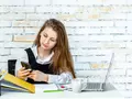 post_big/sweet-school-girl-sitting-her-desk-playing-with-her-phone.jpg