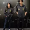 Миниатюра: Хидэо Кодзима и Аша Шарма в худи с логотипами Kojima Production и XBOX