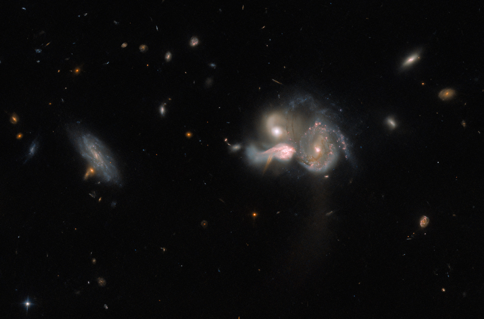 Hubble shows a photo of three massive galaxies merging into one