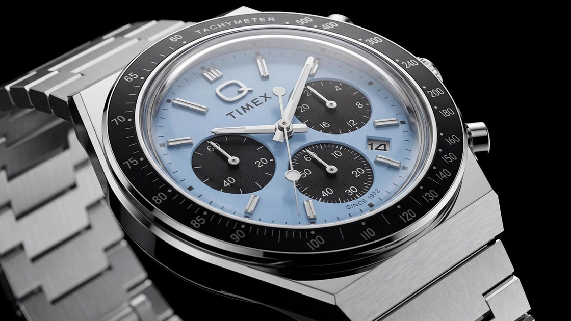 The Q Timex Chronograph in ice-blue and dark green with stainless steel bracelets.