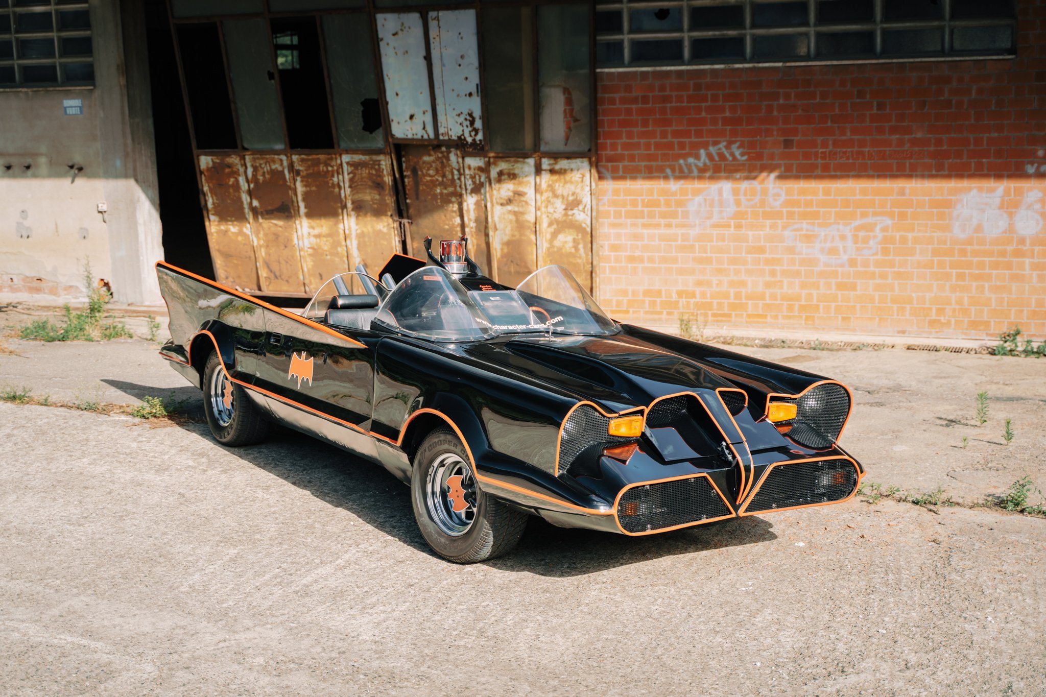 Adam West outside the Batmobile
